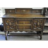 An oak sideboard with panel carved doors 96 cm high 153 cm wide