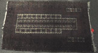 An antique Afghan Baluch rug 160cm x 90cm