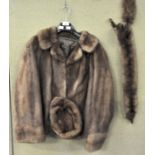 A mink coat and a hat and two pelts