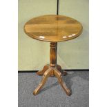 A pale oak round table on column and four splayed legs (66cm high)