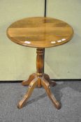 A pale oak round table on column and four splayed legs (66cm high)