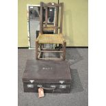 A child's rocking chair along with a mirror and a suitcase