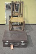 A child's rocking chair along with a mirror and a suitcase