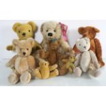 A Merrythought blond plush teddy bear with seven other bears