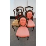 Two continental mahogany salon chairs with oval buttoned padded backs in fancy frames over shaped