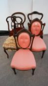 Two continental mahogany salon chairs with oval buttoned padded backs in fancy frames over shaped