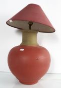 A painted pottery table lamp in the form of a round urn