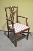 A mahogany armchair with pierced splat back over a tip in seat on square stretched legs