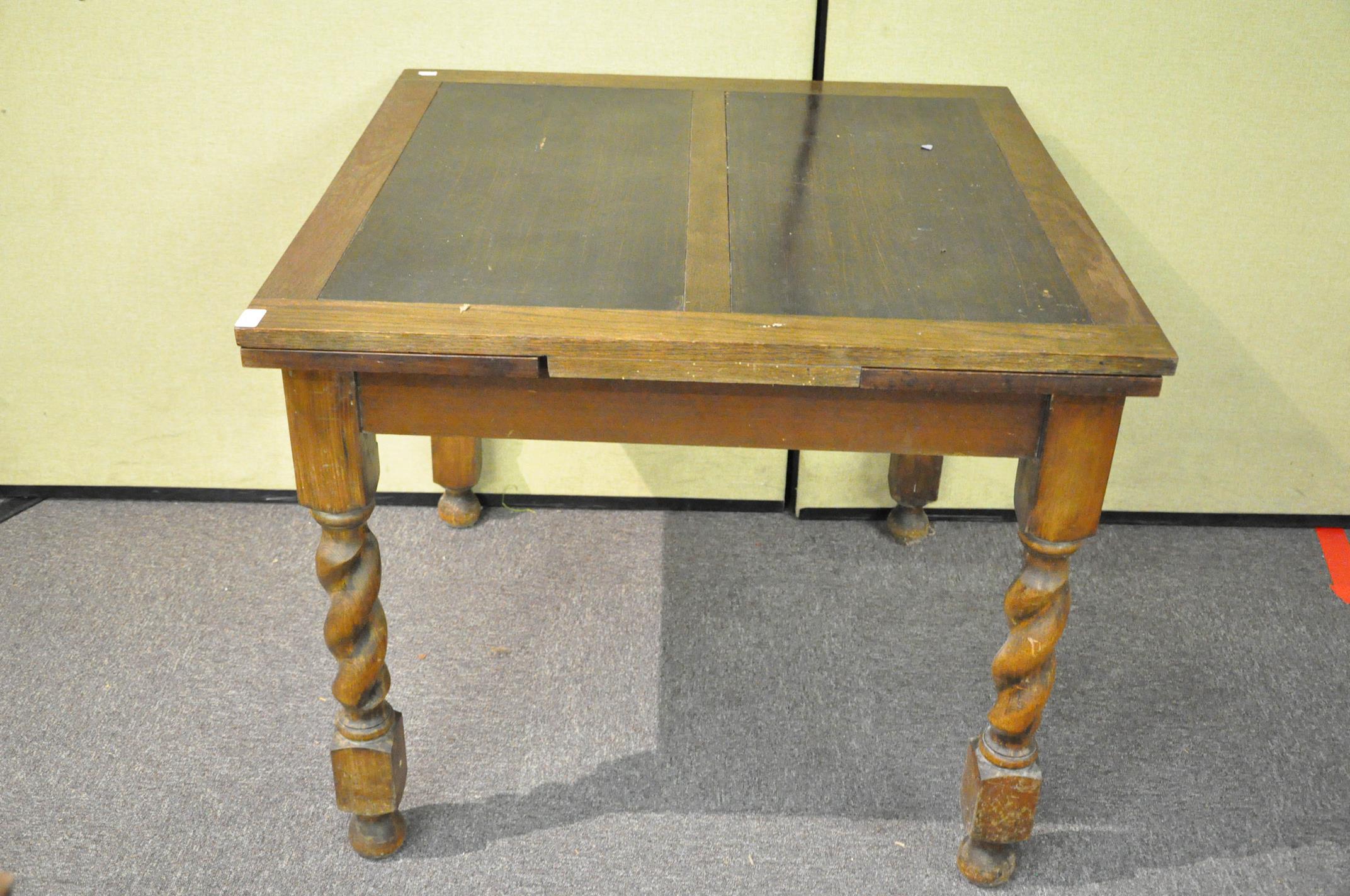 An oak draw leaf table with barley twist legs 76cmH x 90cmW x 90cmD