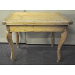 A French pine folding top table on cabriole legs