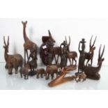 A collection of wooden figures to include elephants and gazelles