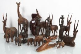 A collection of wooden figures to include elephants and gazelles