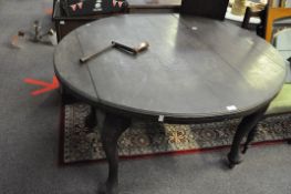 A wind out dining table with one leaf and winder H 70cm,