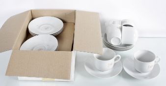 A group of white china cups and saucers boxed and unmarked