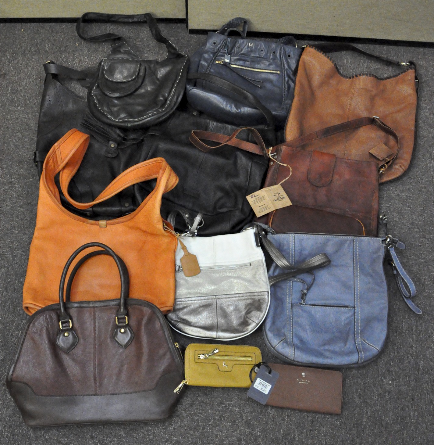 A collection of ten handbags and two purses,