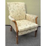 A Parker Knoll armchair with wood arms and legs 91cm H