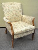 A Parker Knoll armchair with wood arms and legs 91cm H