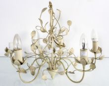 A metal chandelier decorated with foliage,