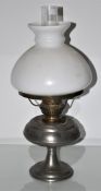 A metal and glass oil lamp