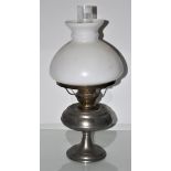 A metal and glass oil lamp
