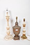 Three lamps, two paint and gilt and an urn