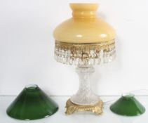 A cut glass lamp and two shades