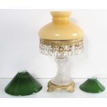 A cut glass lamp and two shades