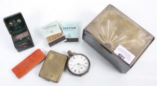 A cigarette box and contents to include a pocket watch,