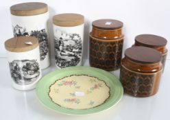 A group of assorted china storage jars and a plate.