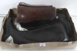 A pair of rubber riding boots and gaiters