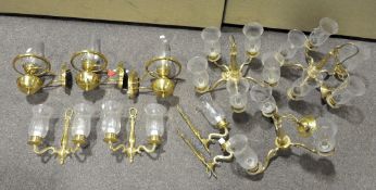 A group of brass and glass ceiling and wall lights