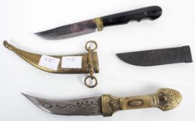 A brass dagger and another dagger in leather scabbard inscribed Innox