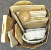 A group of chopping boards and enamel bowls