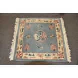 A Chinese pale celadon rug with mountain scene