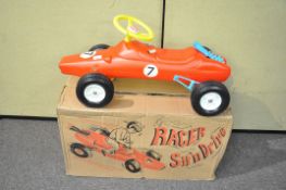 A boxed sit and drive car in style of rally car,