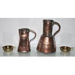 Two Iranian copper ewers and two brass candlesticks