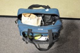 A bag containing a cartridge maker, gloves, shooting glasses,