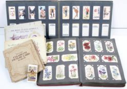 A group of cigarette cards, in album,