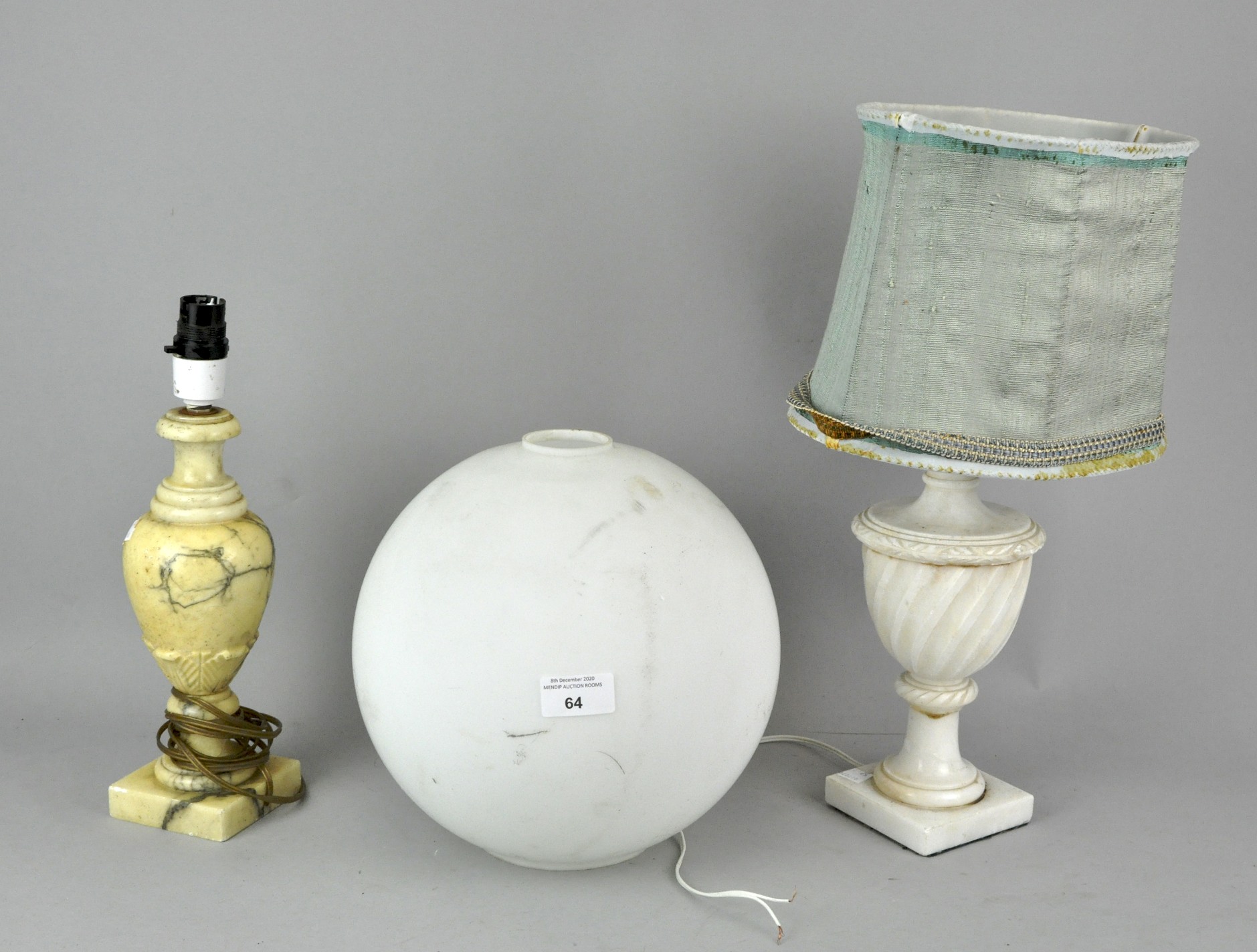 Two carved marble table lamps along with a frosted milk glass globe shade.