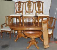 A reproduction oak veneered extending dining table,