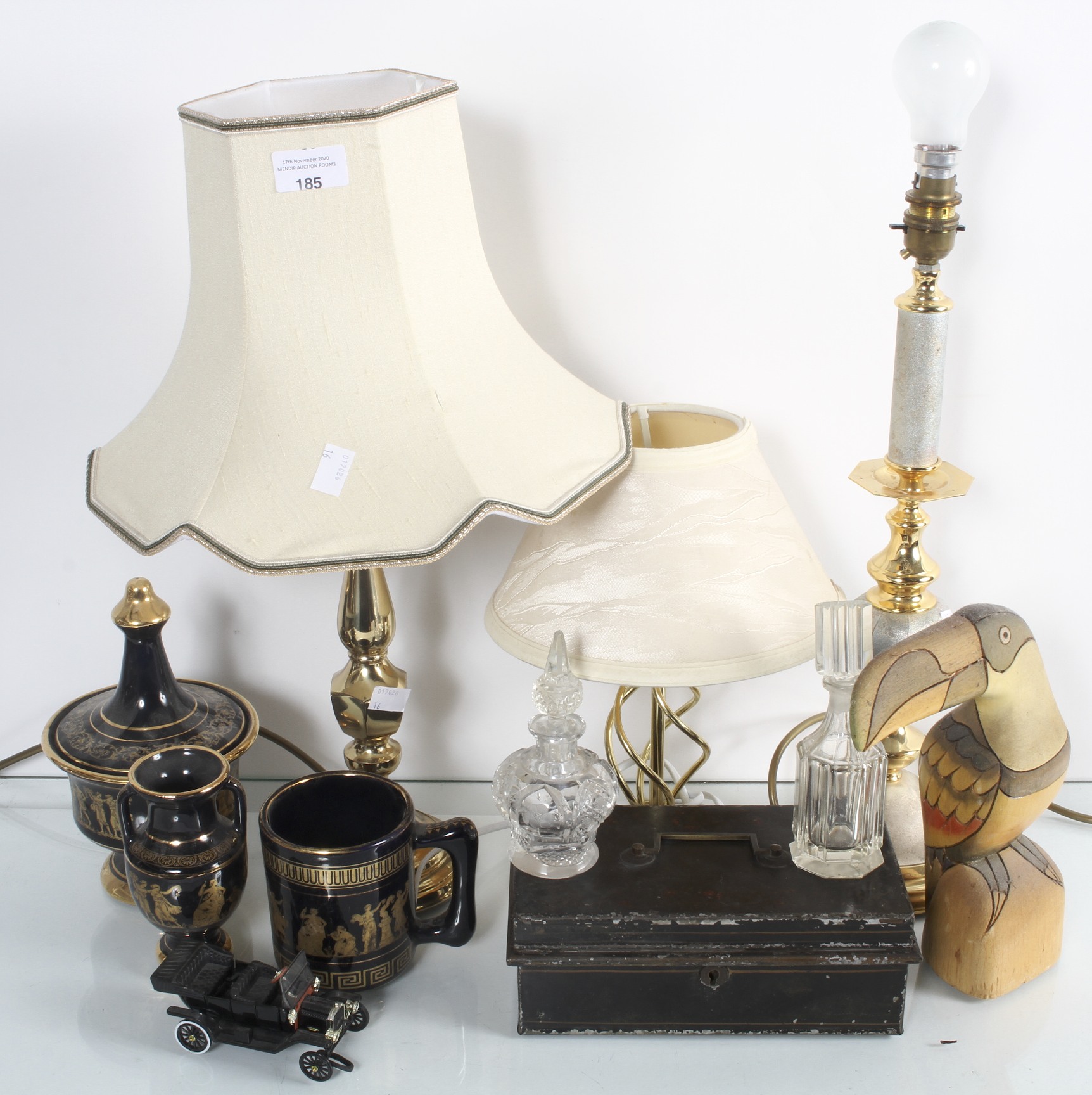 A collection of assorted items to include; three table lamps and carved wooden toucan