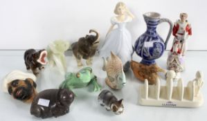 A collection of figures to include a stone hippopotamus, ceramic frog, beefeater bottle.