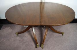 A reproduction twin pedestal mahogany dining table.