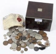A rosewood tea caddy containing a collection of coins,