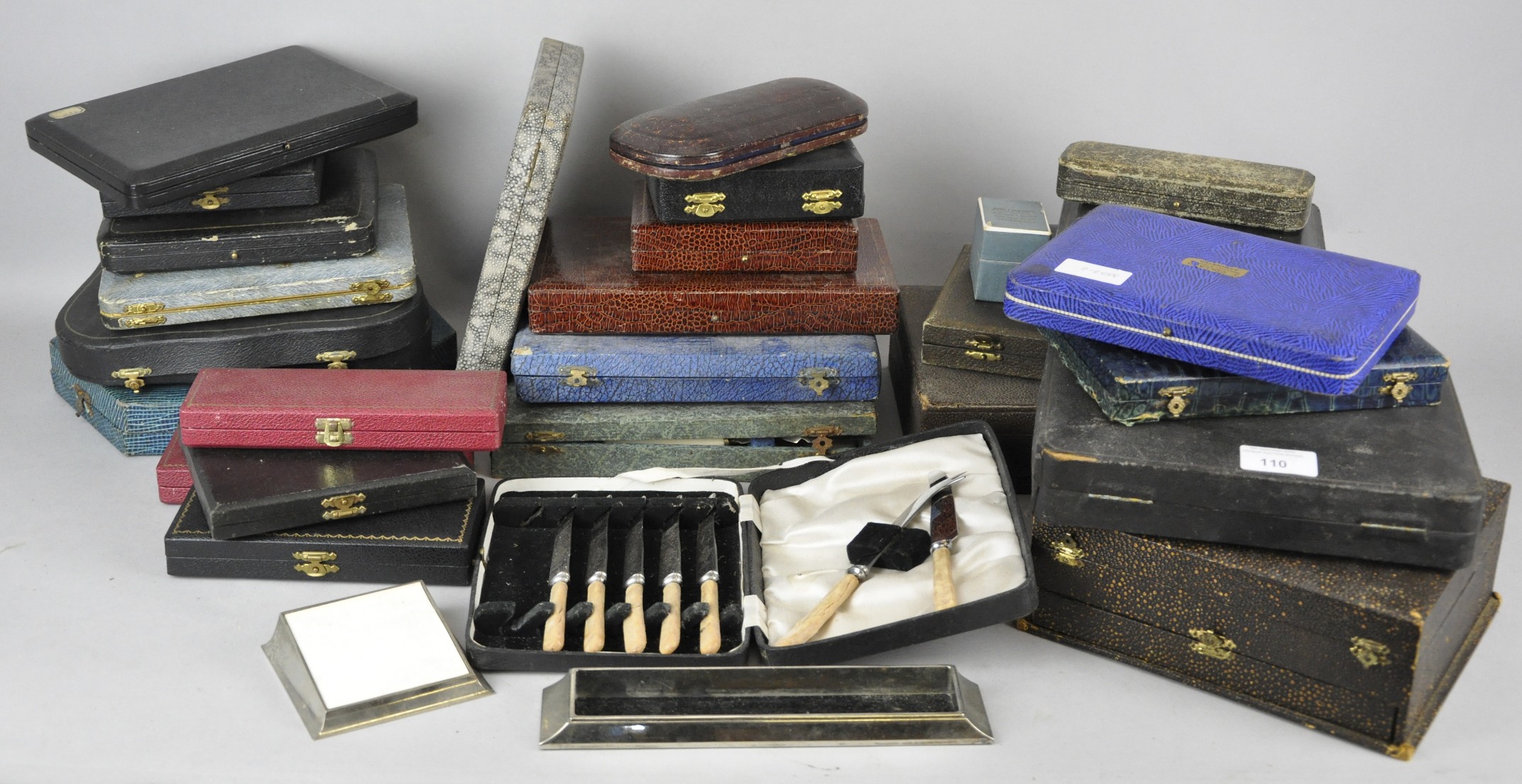 A large collection of assorted empty cutlery boxes of varying sizes.