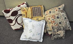 A collection of six assorted cushions in varying patterns.