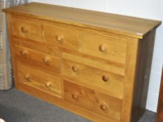 An oak chest of drawers, by Jumbos of Henlow, set three short and four long drawers,