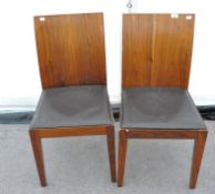 A pair of retro style contemporary chairs with leather seats. Measures; 85cm high.