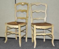 A pair of French style ladder back chairs with rush seats,