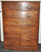 A hard wood bow front chest of six drawers with iron fittings on a plinth base,